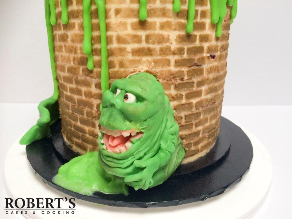 Ghostbusters cake | Ghostbusters cake I made for my best mate's birthday. Slimer and the Staypuft marshmallow man were made with homemade modelling chocolate and Rice Krispy treats, Kellogs LCMs. | https://robertscakesandcooking.com/ghostbusters-cake/